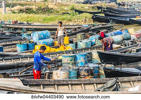Men working in wooden boats with old oil barrels in the harbor, Nampan, Inle Lake, Shan State, Myanmar, Asia View Large Photo Image Stock Image - Men working in wooden boats with old oil barrels in the harbor, Nampan, Inle Lake, Shan State, Myanmar, Asia. Fotosearch
