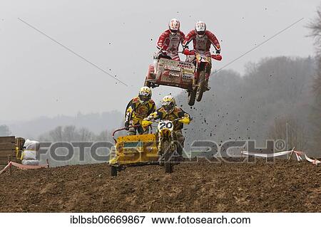 Motorcycle team in the air during a motocross race, Schnaitheim, Baden-Württemberg, Germany, Europe View Large Photo Image Stock Photo - Motorcycle team in the air during a motocross race, Schnaitheim, Baden-Württemberg, Germany, Europe. Fotosearch