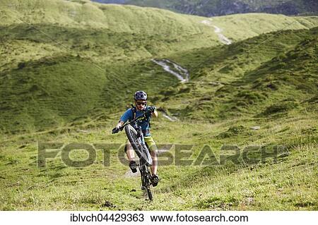 Mountain Biker rides a trail in the hilly landscape, Kalkkögel, Tyrol, Austria, Europe View Large Photo Image Stock Image - Mountain Biker rides a trail in the hilly landscape, Kalkkögel, Tyrol, Austria, Europe. Fotosearch