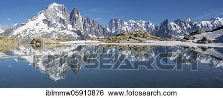 Stock Photograph - Mountain panorama, Lac Blanc, mountain peaks reflected in mountain lake, Grandes Jorasses and Mont Blanc massif, Chamonix-Mont-Blanc, Haute-Savoie, France, Europe. Fotosearch