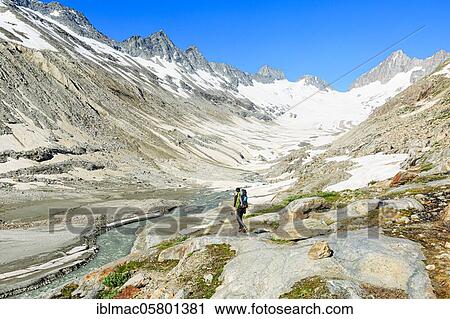 Stock Image - Mountaineer at the foot of the Oberaar glacier, Canton Bern, Switzerland, Europe. Fotosearch