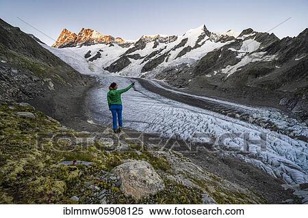Mountaineer standing in front of glacier, high alpine mountain landscape, Lower Ice Sea, Finsteraarhorn, Agasszishorn, Großes Fiescherhorn, Bernese Oberland, Switzerland, Europe View Large Photo Image Stock Photography - Mountaineer standing in front of glacier, high alpine mountain landscape, Lower Ice Sea, Finsteraarhorn, Agasszishorn, Großes Fiescherhorn, Bernese Oberland, Switzerland, Europe. Fotosearch