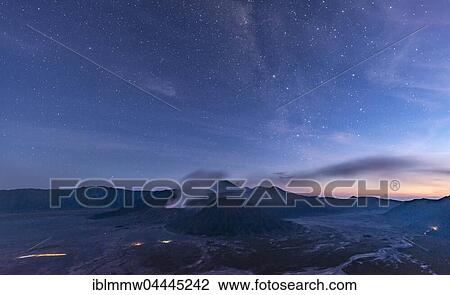 Stock Image - Night sky with stars, smoking volcano Mount Gunung Bromo, Mount Batok in front, Mount Kursi at back, Mount Gunung Semeru, Bromo Tengger Semeru National Park, Java, Indonesia, Asia. Fotosearch