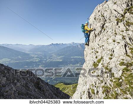 Nordkette fixed-rope route, climber attached to steel cable ascending iron ladder, Nordkette Innsbruck, Tyrol, Austria, Europe View Large Photo Image Stock Image - Nordkette fixed-rope route, climber attached to steel cable ascending iron ladder, Nordkette Innsbruck, Tyrol, Austria, Europe. Fotosearch