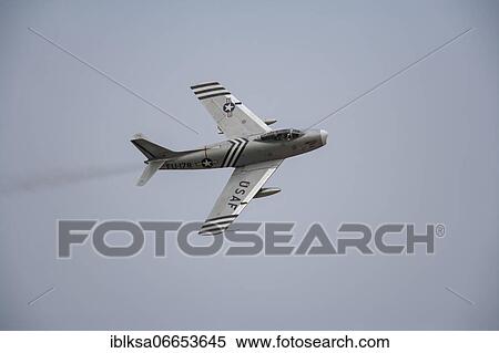 Stock Photography - North American F-86 Sabre aircraft in flight in United States Airforce markings, Cambridgeshire, England, United Kingdom, Europe. Fotosearch