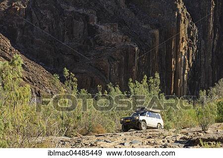 Off-road vehicle in the Ugab riverbed, Damaraland, Kunene Region, Namibia, Africa View Large Photo Image Stock Photo - Off-road vehicle in the Ugab riverbed, Damaraland, Kunene Region, Namibia, Africa. Fotosearch