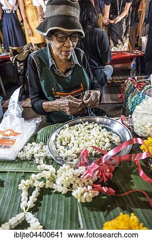 Old woman, Thai woman sells flowers and flower chains at the Night Market, Krabi Town, Krabi Province, Thailand, Asia View Large Photo Image Stock Image - Old woman, Thai woman sells flowers and flower chains at the Night Market, Krabi Town, Krabi Province, Thailand, Asia. Fotosearch