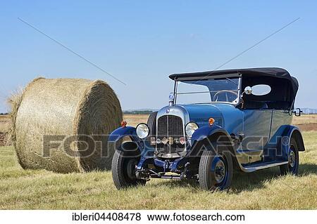 Stock Photo - Oldtimer Citroen B10 in hay field, Torpedo Commerciale, made in 1925, 4-cylinder inline engine, engine capacity 1470 cc, 20 PS, all-steel body. Fotosearch