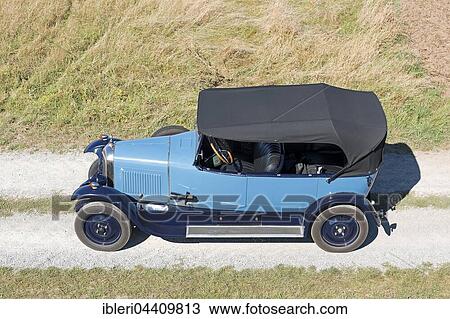 Stock Image - Oldtimer Citroen B10 on gravel road, Torpedo Commerciale, made in 1925. 4-cylinder inline engine, engine capacity 1470 cc, 20 PS, all-steel body. Fotosearch