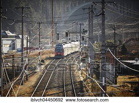 Overhead wires, train track with passenger train, Innsbruck, Tyrol, Austria, Europe View Large Photo Image Stock Image - Overhead wires, train track with passenger train, Innsbruck, Tyrol, Austria, Europe. Fotosearch