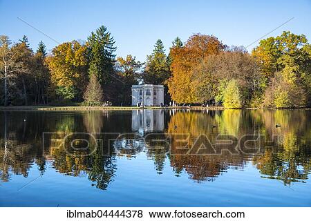 Stock Photo - Pagodenburg reflected in Lake Pagodenburg, Nymphenburg Castle Park, autumn, Munich, Upper Bavaria, Bavaria, Germany, Europe. Fotosearch