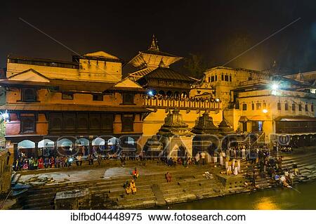 Pashupatinath temple with people at gaths, banks of Bagmati River, illuminated at night, Kathmandu, Kathmandu District, Nepal, Asia View Large Photo Image Stock Photography - Pashupatinath temple with people at gaths, banks of Bagmati River, illuminated at night, Kathmandu, Kathmandu District, Nepal, Asia. Fotosearch