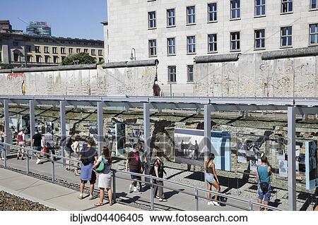 Stock Photography - People viewing the outdoor exhibtion Topographie des Terrors, Topography of Terror at the wall, Berlin, Germany, Europe. Fotosearch