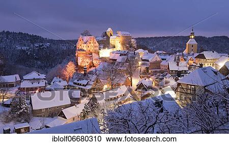 Stock Image - Place Hohnstein with rock castle at snow, blue hour, Saxony, Germany, Europe. Fotosearch