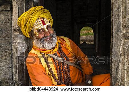 Portait of a Sadhu, holy man, sitting at a shrine at Pashupatinath temple, Kathmandu, Kathmandu District, Nepal, Asia View Large Photo Image Picture - Portait of a Sadhu, holy man, sitting at a shrine at Pashupatinath temple, Kathmandu, Kathmandu District, Nepal, Asia. Fotosearch