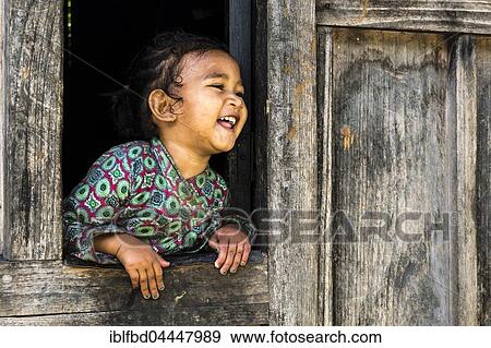 Portrait of loughing little girl, Upper Marsyangdi valley, looking out of a window, Bagarchap, Manang District, Nepal, Asia View Large Photo Image Stock Photo - Portrait of loughing little girl, Upper Marsyangdi valley, looking out of a window, Bagarchap, Manang District, Nepal, Asia. Fotosearch