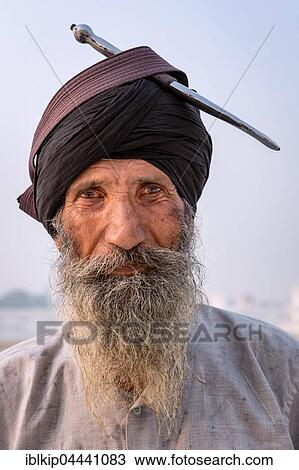 Stock Image - Portrait, Sikh pilgrim with his knife on top of his turban, Harmandir Sahib or Golden Temple, Amritsar, Punjab, India, Asia. Fotosearch