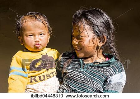 Portrait, young girl hugging even younger boy, Ghandruk, Kaski District, Nepal, Asia View Large Photo Image Stock Image - Portrait, young girl hugging even younger boy, Ghandruk, Kaski District, Nepal, Asia. Fotosearch