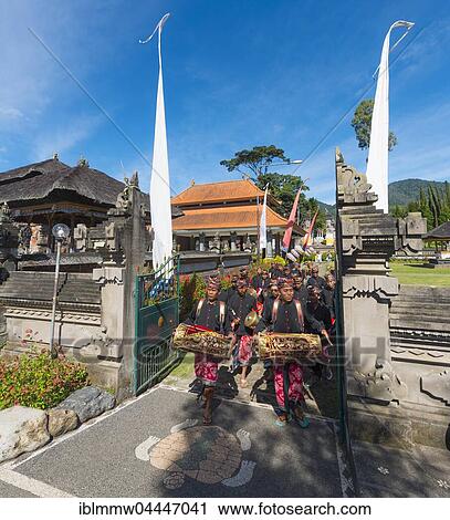 Stock Image - Procession of devout Buddhists at water temple Pura Ulun Danu Bratan water temple, Lake Bratan, Bali, Indonesia, Asia. Fotosearch