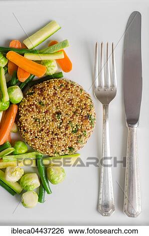 Quinoa burger with vegetables and cutlery View Large Photo Image Stock Photograph - Quinoa burger with vegetables and cutlery. Fotosearch