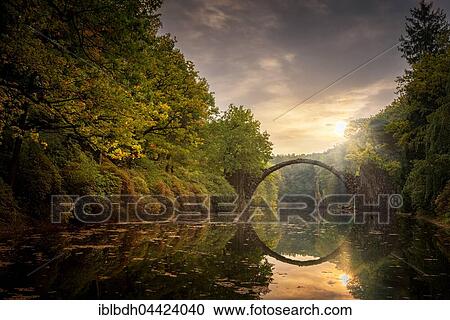 Stock Image - Rakotzbrücke or Teufelsbrücke, bridge in Kromlauer Park, Kromlau, Saxony, Germany, Europe. Fotosearch