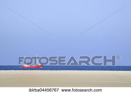 Red fishing boat in the North Sea, St. Peter-Ording Beach, Schleswig-Holstein Wadden Sea National Park, North Frisia, Schleswig-Holstein, Germany, Europe View Large Photo Image Stock Photo - Red fishing boat in the North Sea, St. Peter-Ording Beach, Schleswig-Holstein Wadden Sea National Park, North Frisia, Schleswig-Holstein, Germany, Europe. Fotosearch