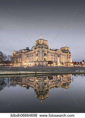 Stock Photo - Reichstag with waving German flag at the Spree, government quarter, Berlin, Germany, Europe. Fotosearch