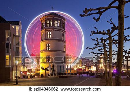 Rhine promenade with Castle Tower and illuminated Ferris wheel at dusk, Düsseldorf, North Rhine-Westphalia, Germany, Europe View Large Photo Image Stock Image - Rhine promenade with Castle Tower and illuminated Ferris wheel at dusk, Düsseldorf, North Rhine-Westphalia, Germany, Europe. Fotosearch