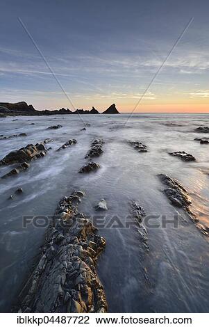 Stock Image - Rocks in the sea, rocky coast, Atlantic Coast, Hartland Quay, Devon, United Kingdom, Europe. Fotosearch