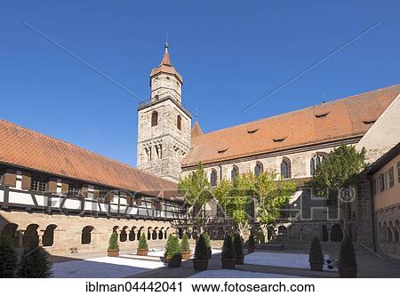 Stock Image - Romanesque cloister and Evangelical Church, Feuchtwangen, Middle Franconia, Franconia, Bavaria, Germany, Europe. Fotosearch