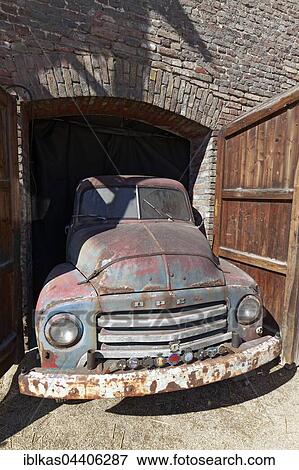 Rusted vintage Opel Blitz 1960, in opening of a garage, Niederrhein, North Rhine-Westphalia, Germany, Europe View Large Photo Image Stock Photo - Rusted vintage Opel Blitz 1960, in opening of a garage, Niederrhein, North Rhine-Westphalia, Germany, Europe. Fotosearch