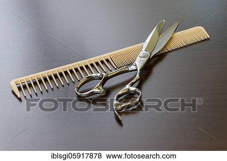 Scissors and comb lie on a table View Large Photo Image Stock Photo - Scissors and comb lie on a table. Fotosearch
