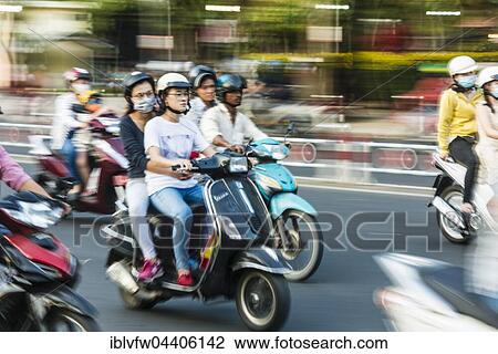 Stock Image - Scooter drivers in heavy traffic, motion blur, Ho Chi Minh City, Vietnam, Asia. Fotosearch