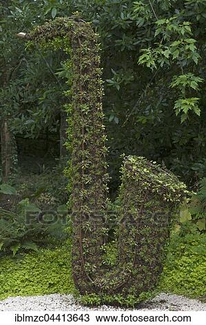 Stock Image - Sculpture from plants, saxophone, Parc Floral et Tropical de la Court d&#39; Aron, Saint Cyr en Talmondais, Vandee, France, Europe. Fotosearch