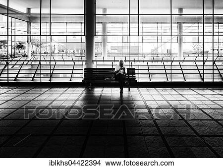 Picture - Senior sitting on a bench in the covered market, Funchal, Madeira, Portugal, Europe. Fotosearch