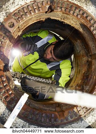 Sewer cleaning, worker on ladder inspecting with a flashlight, Innsbruck, Tyrol, Austria, Europe View Large Photo Image Stock Image - Sewer cleaning, worker on ladder inspecting with a flashlight, Innsbruck, Tyrol, Austria, Europe. Fotosearch
