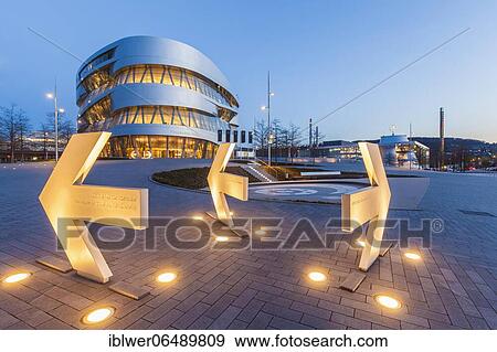 Stock Photo - Signpost Daimler Group Headquarters, behind it Mercedes-Benz Museum, Stuttgart, Baden-Württemberg, Germany, Europe. Fotosearch