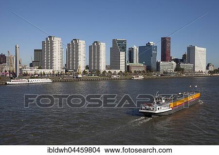 Skyline with skyscrapers on Boompjeskai, cargo ship on the Nieuwe Maas River, Rotterdam, Holland, Netherlands View Large Photo Image Picture - Skyline with skyscrapers on Boompjeskai, cargo ship on the Nieuwe Maas River, Rotterdam, Holland, Netherlands. Fotosearch