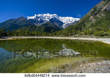 Snowcapped mountain Annapurna 2, mirroring in a lake, Upper Marsyangdi valley, Lower Pisang, Manang District, Nepal, Asia View Large Photo Image Picture - Snowcapped mountain Annapurna 2, mirroring in a lake, Upper Marsyangdi valley, Lower Pisang, Manang District, Nepal, Asia. Fotosearch