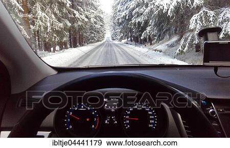 Snowy forest road, view through car windshield, Germany, Europe View Large Photo Image Stock Photo - Snowy forest road, view through car windshield, Germany, Europe. Fotosearch