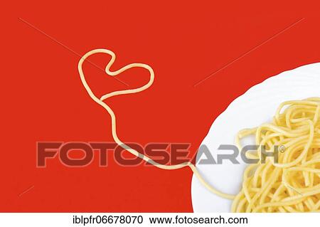 Spaghetti in heart shape on red background View Large Photo Image Stock Image - Spaghetti in heart shape on red background. Fotosearch