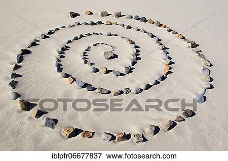 Spiral of stones on sandy beach View Large Photo Image Stock Photo - Spiral of stones on sandy beach. Fotosearch