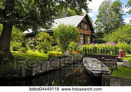 Spreewald house with boat on Fließ river, Lehde district, Lübbenau, Spreewald, Spreewald Nature Reserve and Biosphere Reserve, Brandenburg, Germany, Europe View Large Photo Image Stock Photo - Spreewald house with boat on Fließ river, Lehde district, Lübbenau, Spreewald, Spreewald Nature Reserve and Biosphere Reserve, Brandenburg, Germany, Europe. Fotosearch