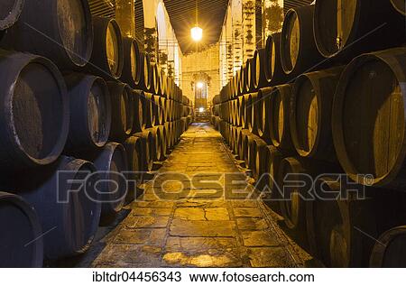Stock Image - Stacked oak barrels in the wine cellar, winery Bodega Fundador Pedro Domecq, Jerez de la Frontera, Cadiz province, Andalusia, Spain, Europe. Fotosearch