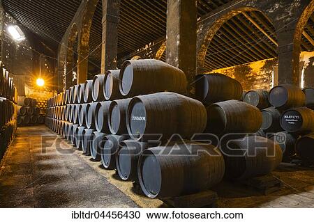 Stock Image - Stacked oak barrels in the wine cellar, winery Bodega Fundador Pedro Domecq, Jerez de la Frontera, Cadiz province, Andalusia, Spain, Europe. Fotosearch
