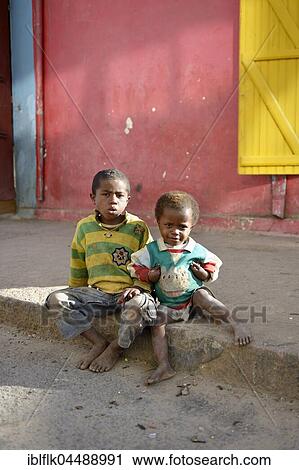 Street children, two little boys sitting at the side of the road, Fianarantsoa province, Madagascar, Africa View Large Photo Image Stock Image - Street children, two little boys sitting at the side of the road, Fianarantsoa province, Madagascar, Africa. Fotosearch