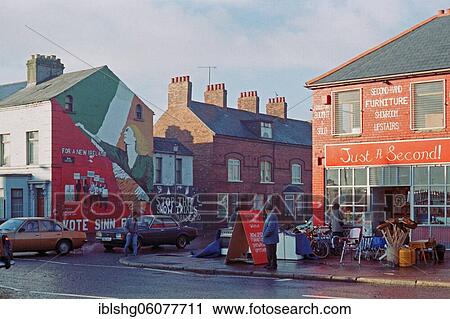 Street scene with car traffic and shops, graffiti on building facades, historical photo, 24. 01. 1986, Falls Road quarter, Belfast, Northern Ireland View Large Photo Image Stock Image - Street scene with car traffic and shops, graffiti on building facades, historical photo, 24. 01. 1986, Falls Road quarter, Belfast, Northern Ireland. Fotosearch