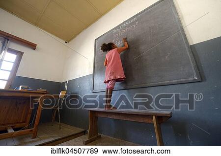 Stock Photo - Student, girl writing at blackboard in primary school, Fianarantsoa, Madagascar, Africa. Fotosearch
