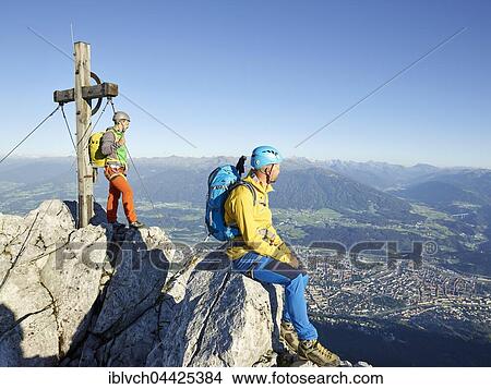 Summit cross Nordkette, two climbers enjoying view at top, Nordkette Innsbruck, Tyrol, Austria, Europe View Large Photo Image Picture - Summit cross Nordkette, two climbers enjoying view at top, Nordkette Innsbruck, Tyrol, Austria, Europe. Fotosearch