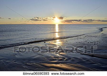 Stock Image - Sunset at the sandy beach Nebel, Amrum, North Frisian Island, North Frisia, Schleswig-Holstein, Germany, Europe. Fotosearch